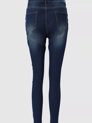 Dark blue skinny jeans with zipper detail and raw hem