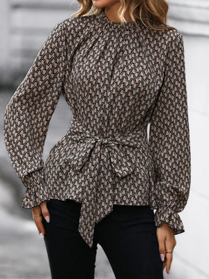 Tied ruffled flounce sleeve blouse in khaki with a geometric print and tie waist.