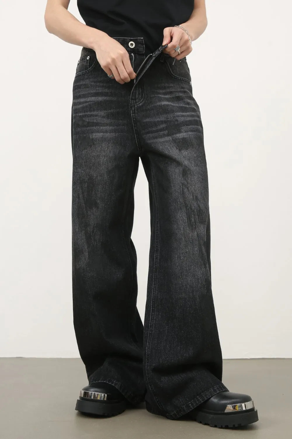Oversized charcoal wash denim jeans with a wide leg and distressed details.