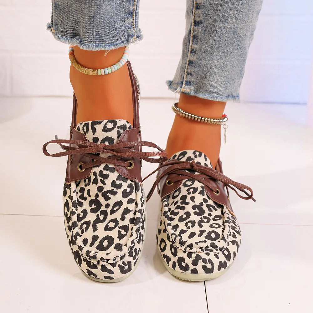 Leopard print boat shoes with leather accents and lace-up detail in cream.