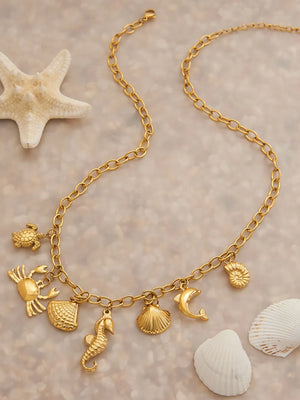 necklace in gold with geometric and multiple marine-inspired pendants