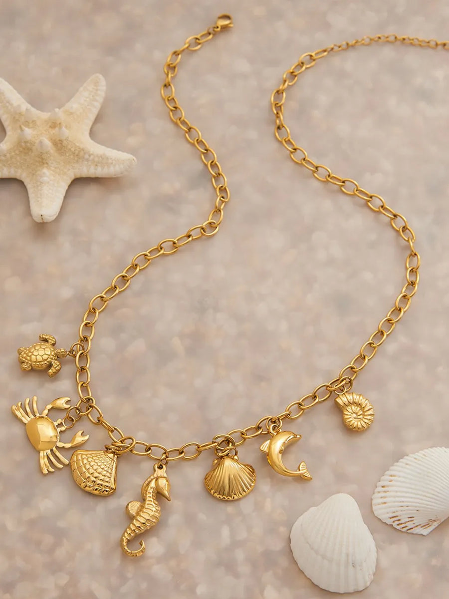 necklace in gold with geometric and multiple marine-inspired pendants