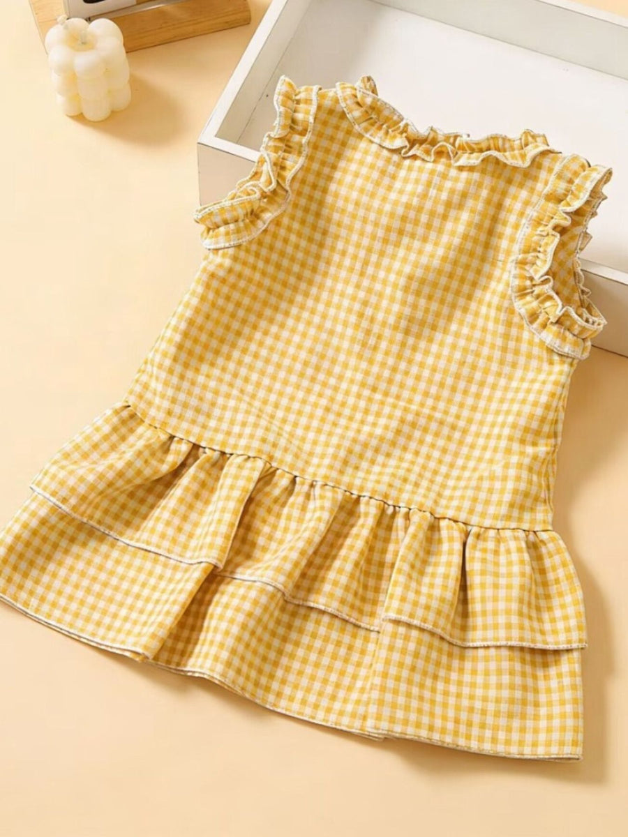 Yellow gingham baby dress with ruffled neckline and tiered skirt.