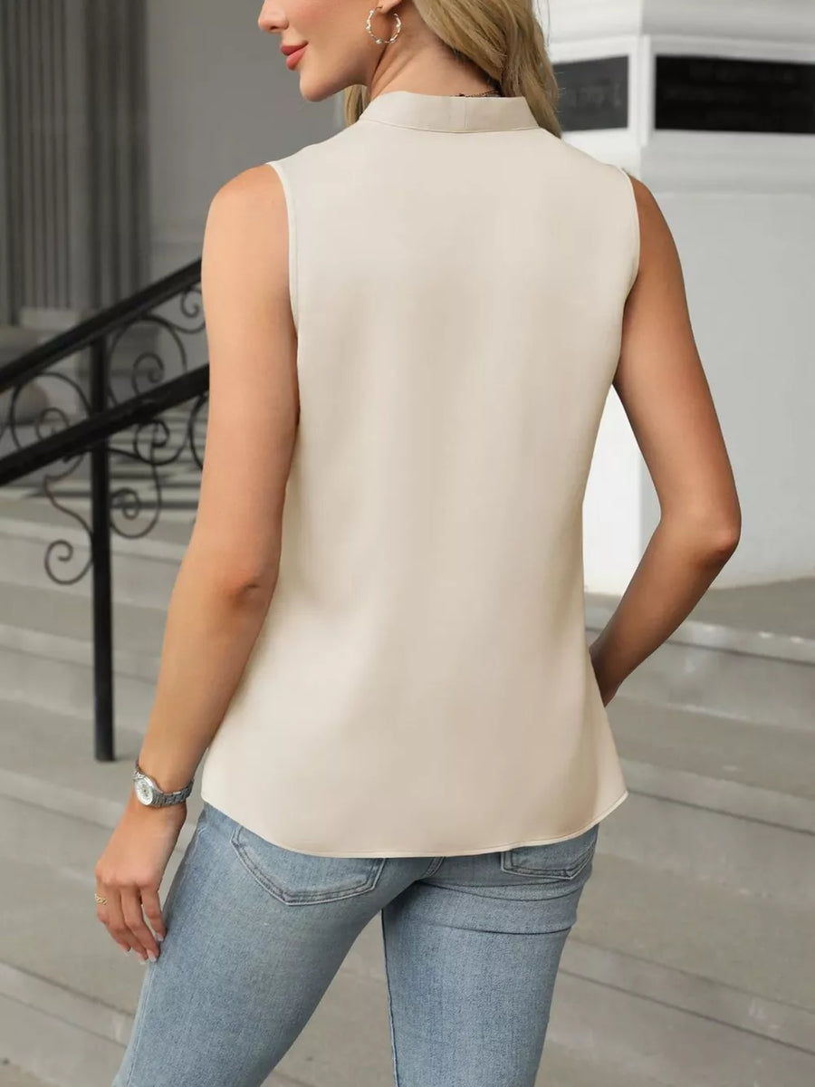 Apricot satin V-neck tank top with a high neckline and sleeveless cut.