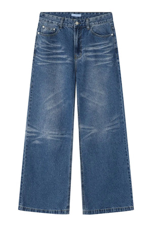 Wide-leg distressed denim jeans in medium wash with whiskering details.