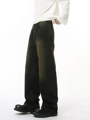 Dark distressed denim jeans with a relaxed fit and gradient wash.