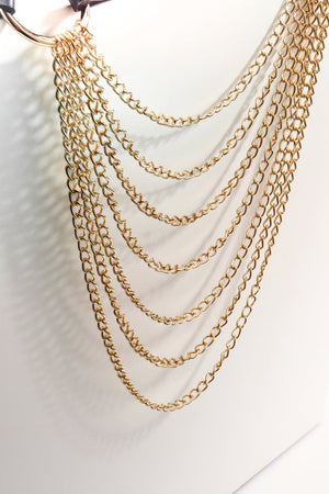 Cascading chain waist harness in gold with multiple layered chains.