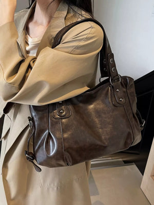 Large vintage brown PU leather shoulder bag with silver hardware and a slouchy design.
