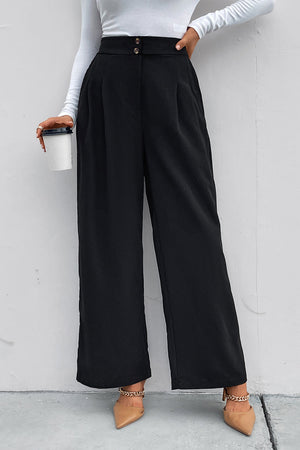 Black high-rise ruched wide-leg trousers with a button closure and pleats.