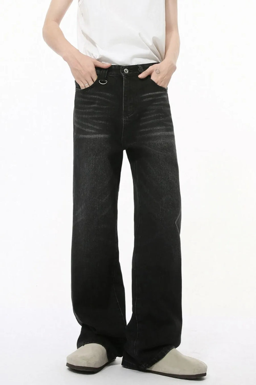 Dark wash wide leg denim jeans with statement pockets and a metal ring detail.