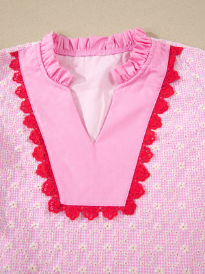 Pink eyelet embroidered blouse with red lace trim and ruffled neckline