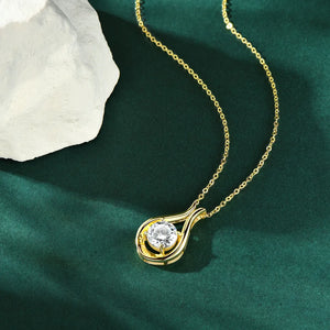 Gold teardrop pendant necklace with a round moissanite stone.