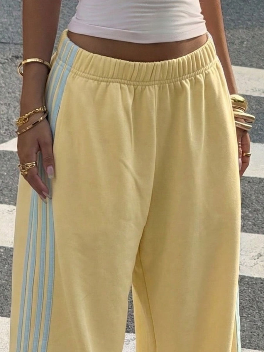 Light Gray track pants featuring high-waisted and striped