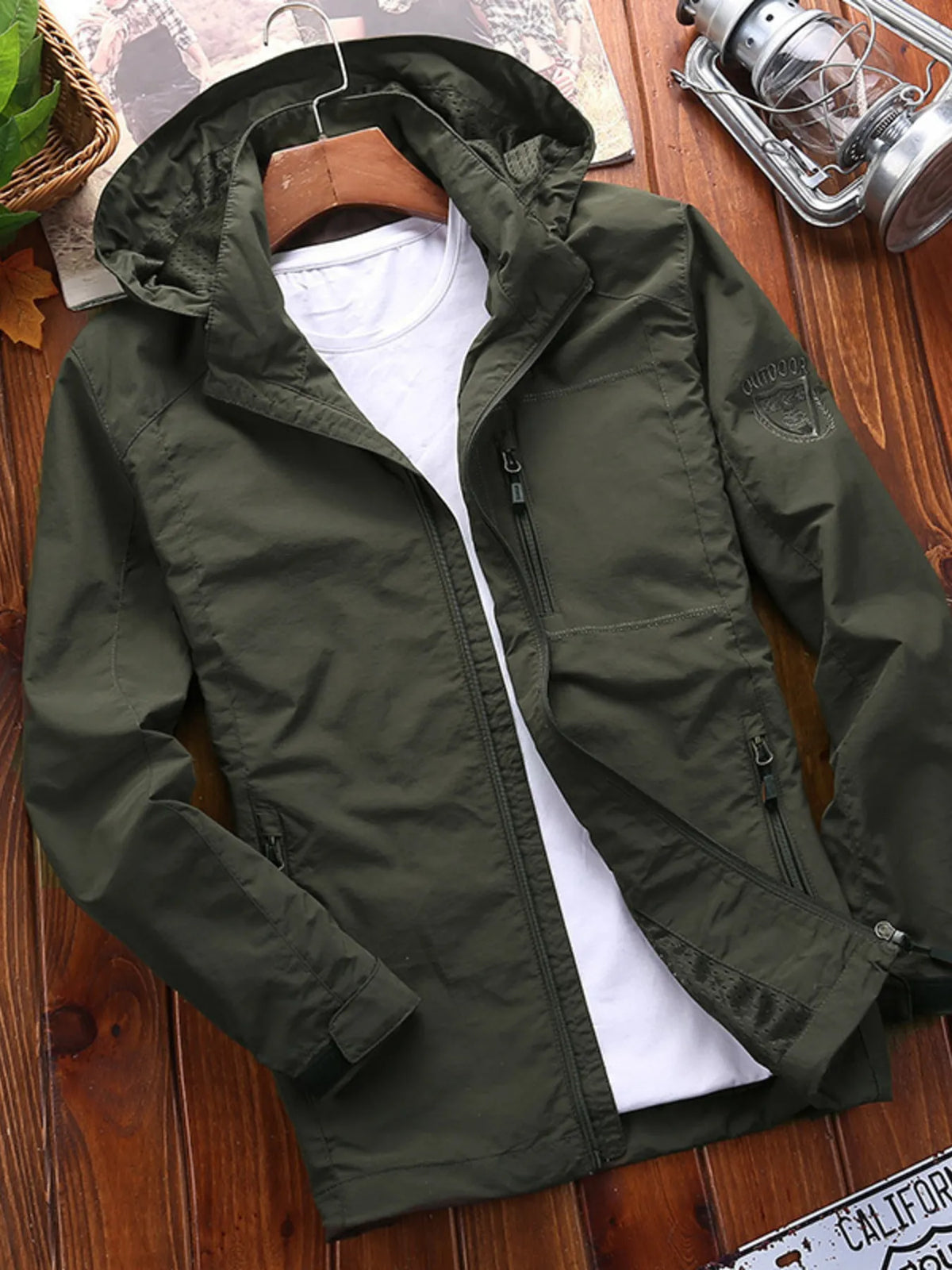 Men's hooded jacket in Army Green with zip pockets and embroidered patch detail.