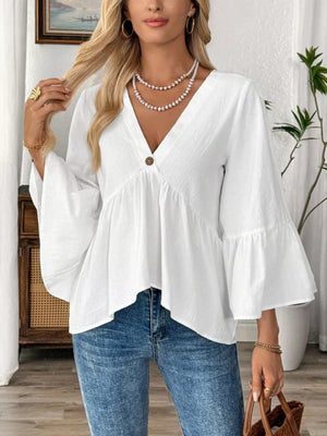 White cotton V-neck peasant blouse with bell sleeves and a single button detail.
