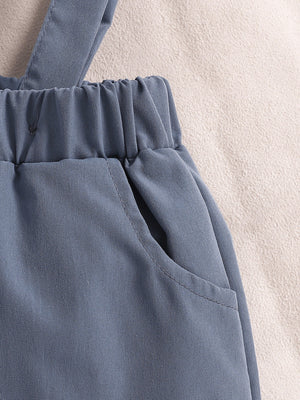 Sky blue baby suspender shorts with elastic waistband and pocket detail.