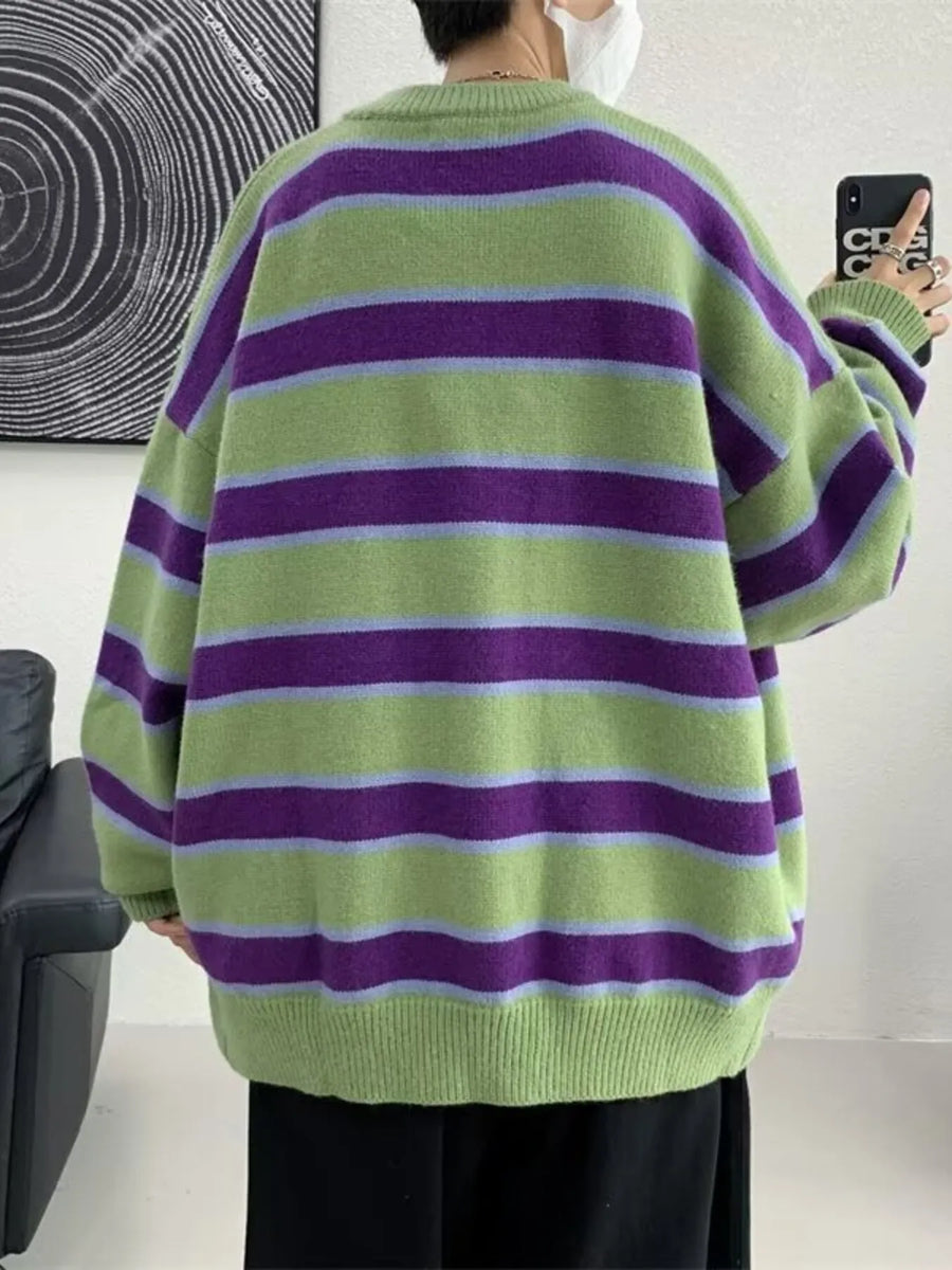 Oversized green striped V-neck cardigan with purple and light blue stripes.