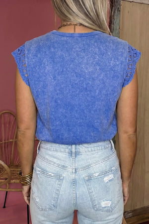 Blue mineral wash cotton tee with distressed details and lace cap sleeves.