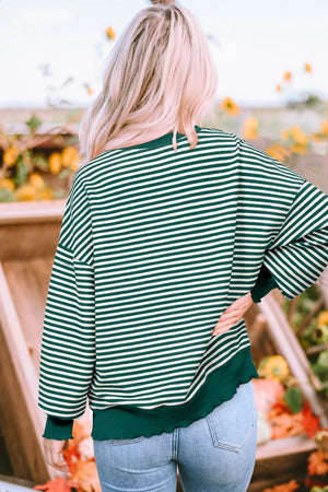 Dark green and white striped sweatshirt with lettuce hem detail.