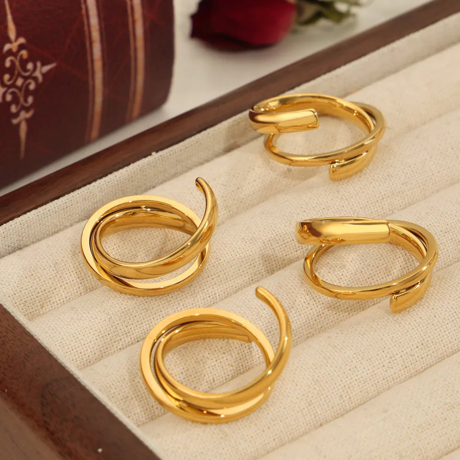 Gold sculptural spiral steel ring with modern open design