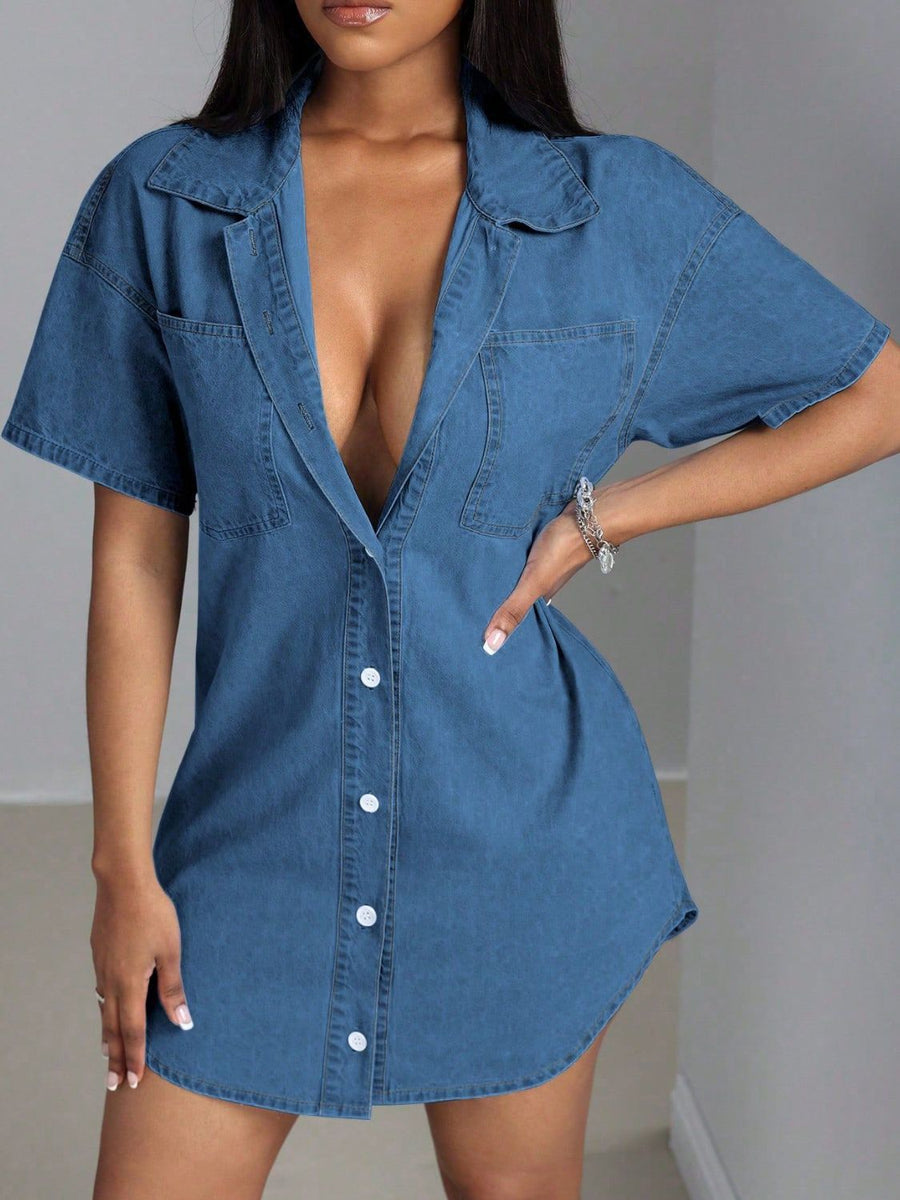 Oversized denim shirt dress in medium wash with a deep plunge neckline, collared, short sleeves, and button front.