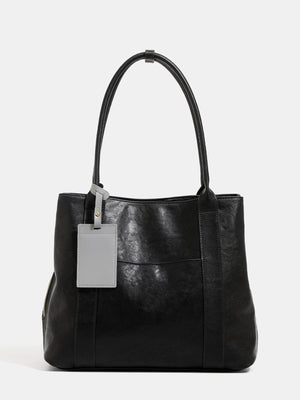 tote in black featuring shoulder straps and boxy fit
