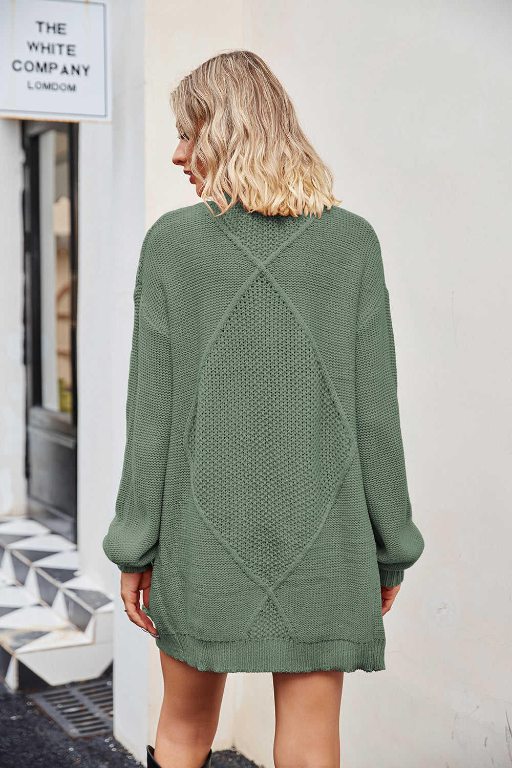 Cable knit cardigan in Gum Leaf acrylic with diamond pattern detail on back.