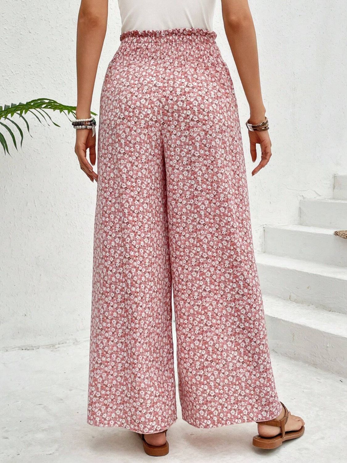 Blush pink floral print palazzo pants with a smocked waist and wide leg