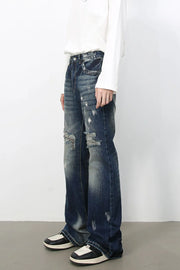 Distressed flare jeans in medium wash denim with raw edge finish and ripped details.