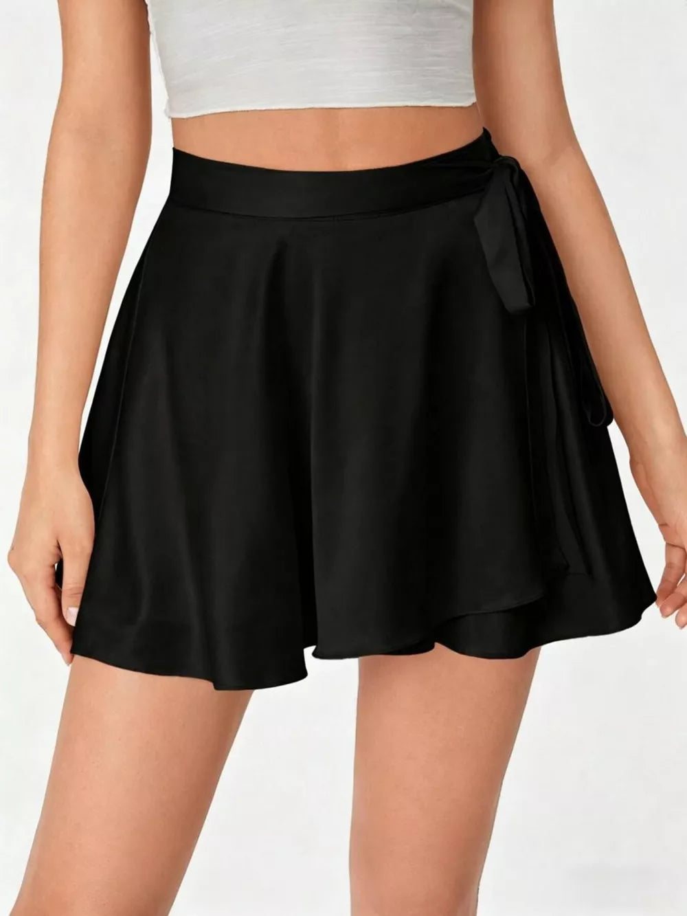 Black A-line mini skirt with tie detail and a flared hem