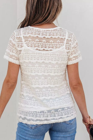 White sheer lace t-shirt with short sleeves and intricate patterned details, worn over a camisole.