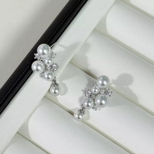 Light gray pearl and zircon cluster earrings with dangling pearl accents.