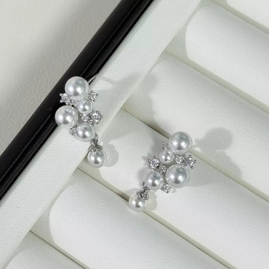 Light gray pearl and zircon cluster earrings with dangling pearl accents.