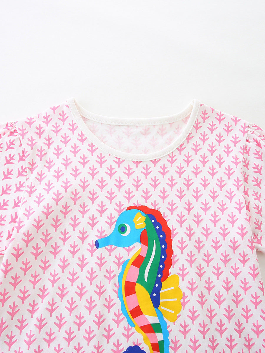 White cotton crew neck t-shirt with pink leaf pattern and colorful seahorse graphic.