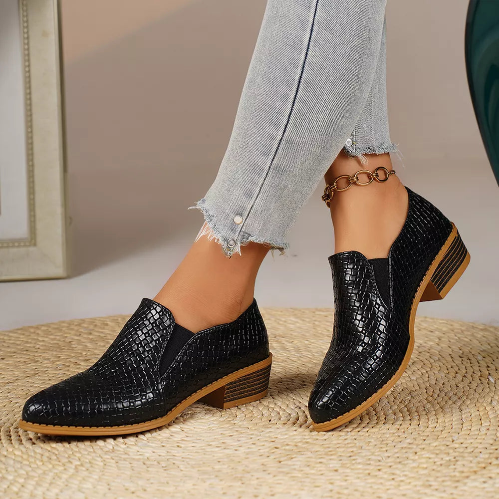 Black woven texture pointed loafers with block heels and elastic side panels.