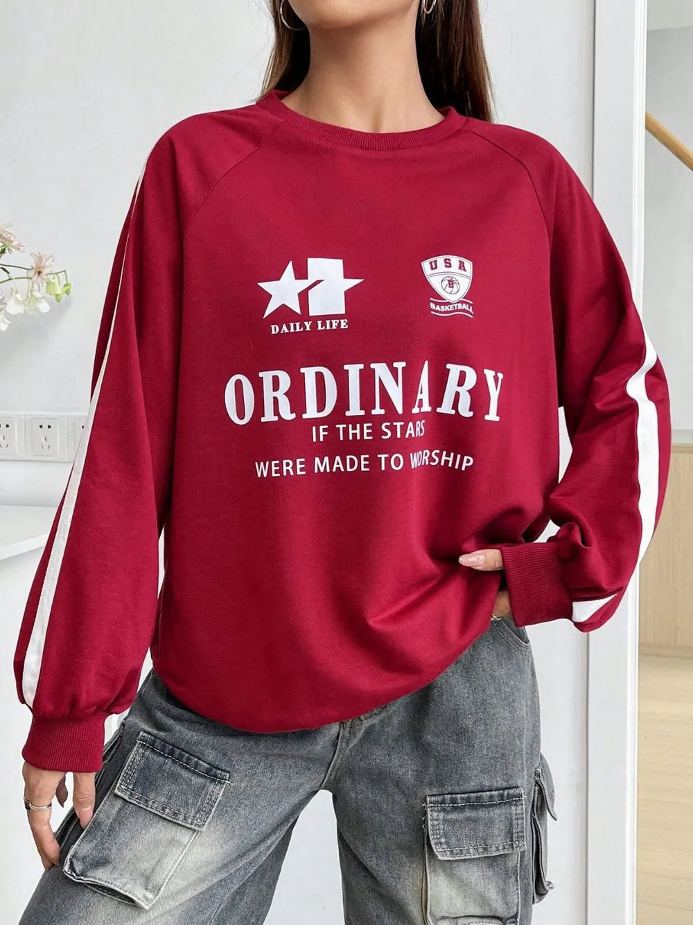 Deep red graphic raglan sleeve sweatshirt with white stripe details and "ORDINARY" text.