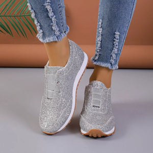 Silver glittering round toe slip-on flats with elastic detail.