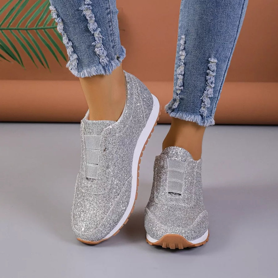 Silver glittering round toe slip-on flats with elastic detail.