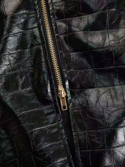 Black crocodile-embossed bodycon midi dress detail with gold zipper.