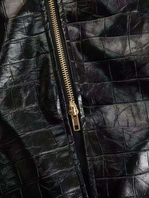 Black crocodile-embossed bodycon midi dress detail with gold zipper.