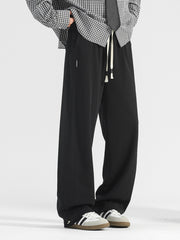 Men's black casual loose-fit drawstring pants with pockets and white drawstrings.