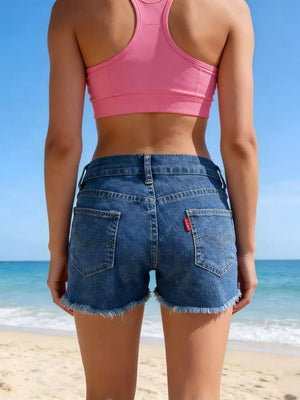Classic blue denim shorts with frayed hem and button fly, shown from the back.