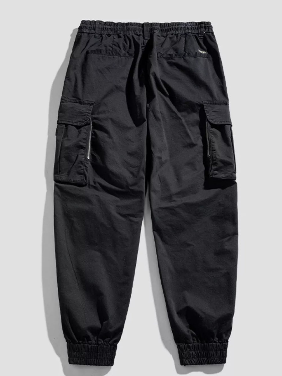 Black cargo joggers with flap pockets and zippered details.