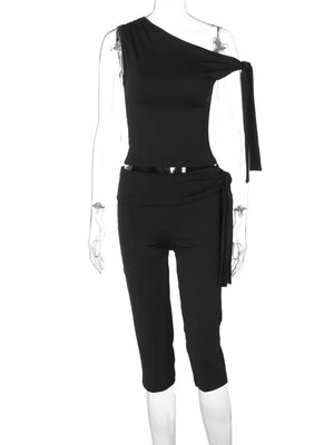 Black asymmetrical one-shoulder top with tie detail and capri pants with tie waist