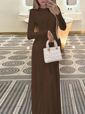 Brown ruched long sleeve maxi dress with boat neckline, bodycon fit.