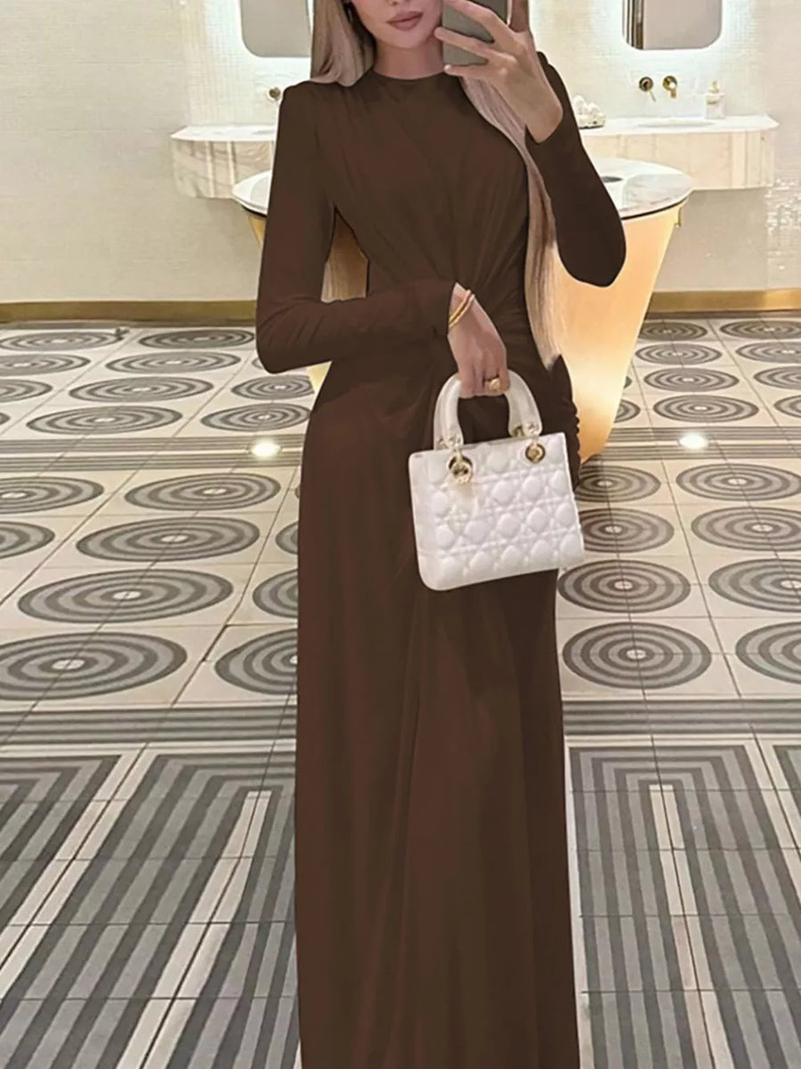 Brown ruched long sleeve maxi dress with boat neckline, bodycon fit.