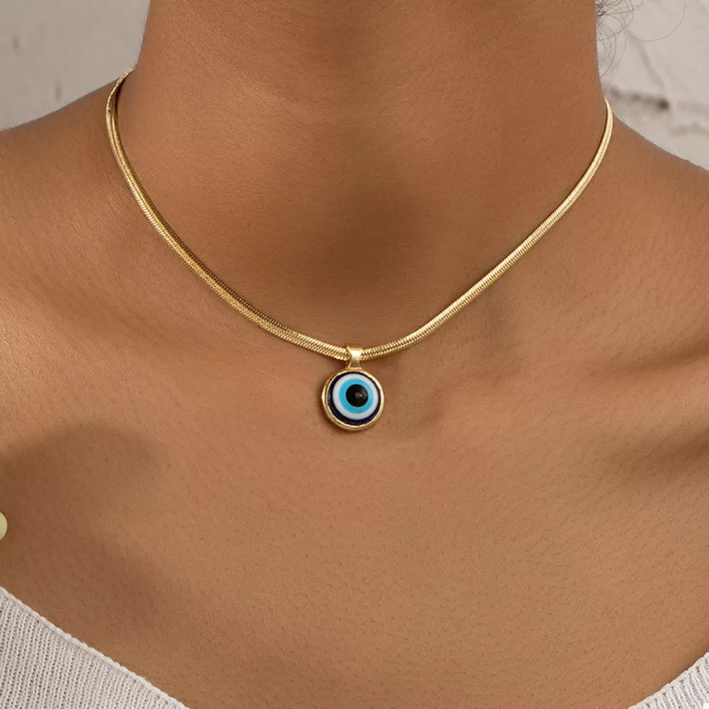 gold necklace with evil eye motif and n/a
