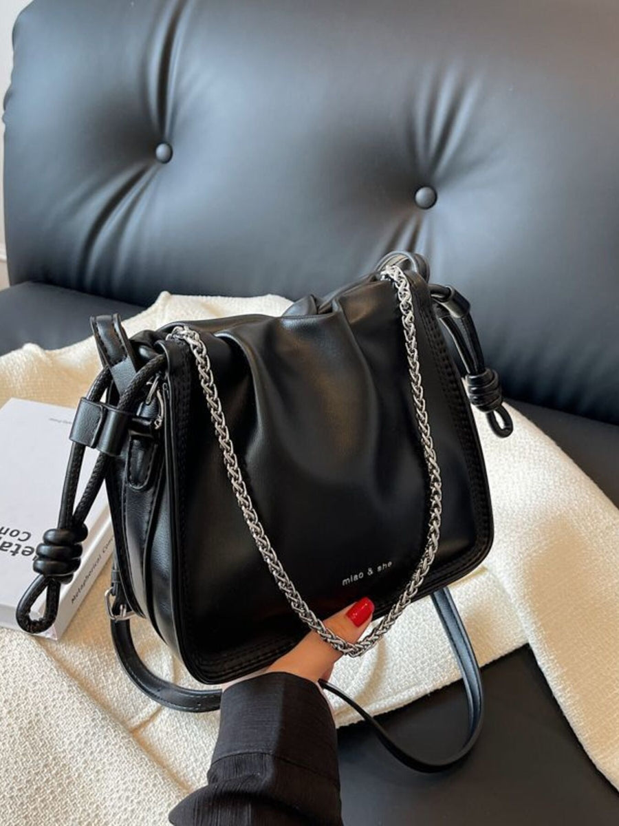 Black ruched PU leather crossbody bag with silver chain strap and knotted detail