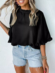 Black ruffled mock neck half sleeve shirt with ruffled cuffs.