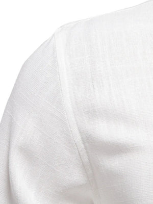 White linen shirt detail showing shoulder seam and textured fabric.
